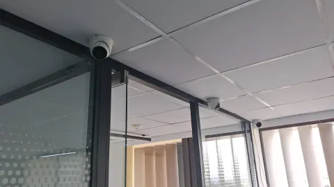 Illustrative office corridor with CCTV cameras