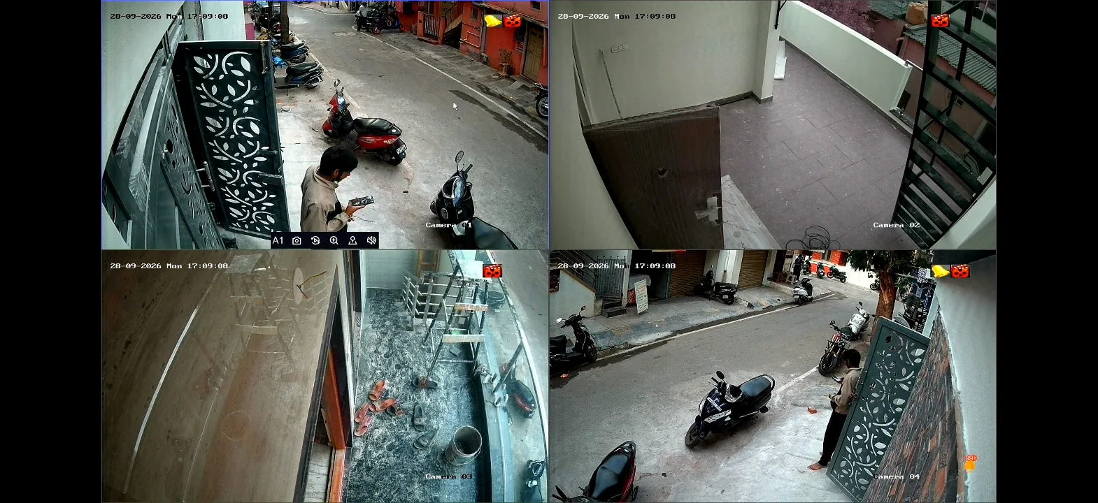 Four CCTV views showing a street and building access areas